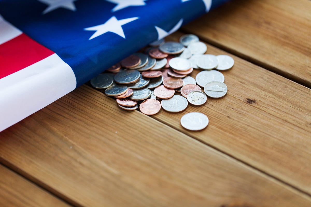 budget-finance-money-crisis-nationalism-concept-close-up-american-flag-cent-coins (1)